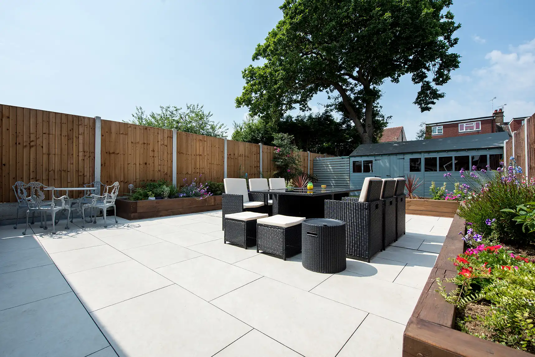 Helle keramische Terrassenplatten auf moderner Terrasse im Garten